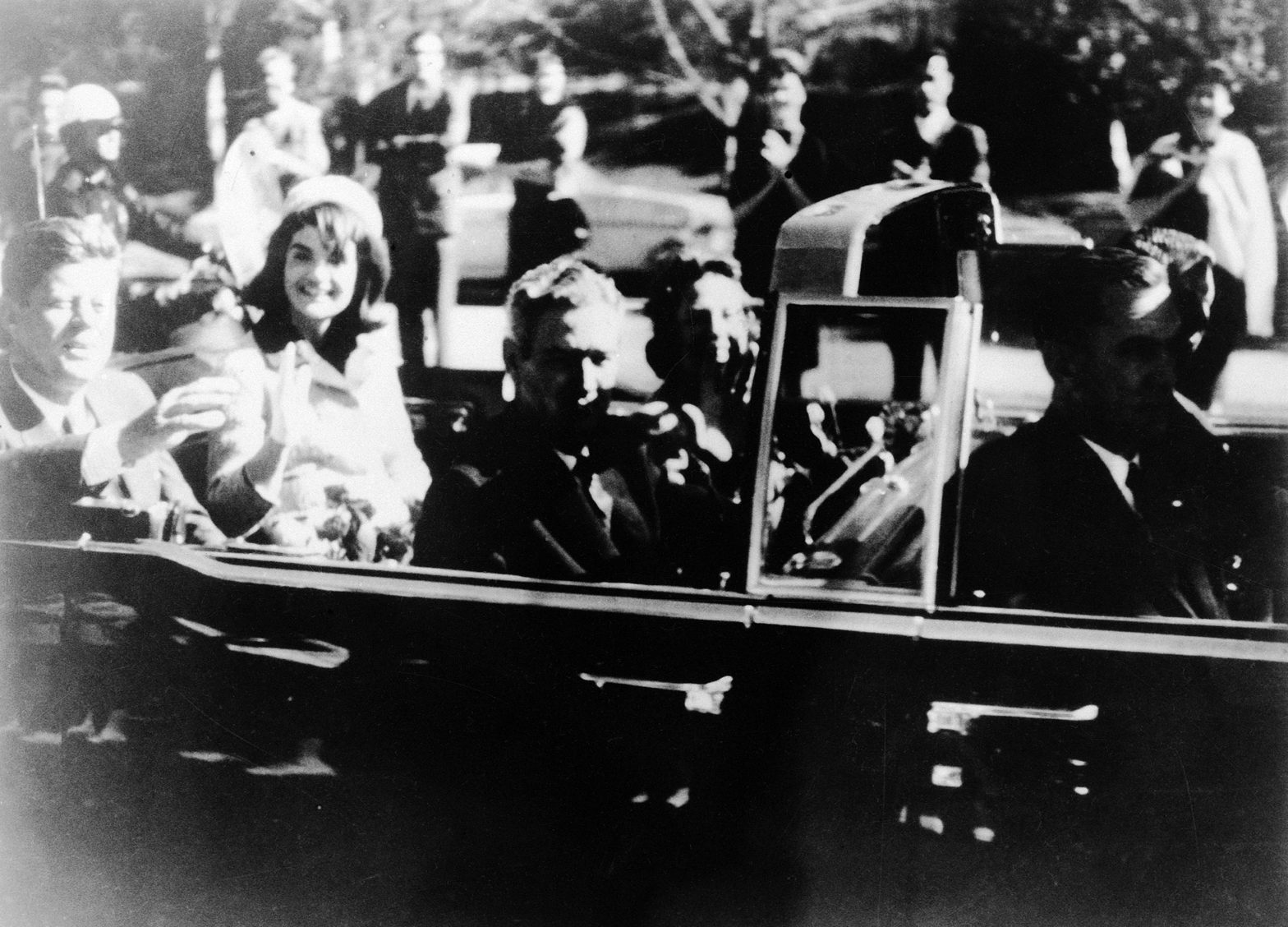 This is Warren Commission Exhibit No. 697, President John F. Kennedy at the extreme right on rear seat of his limousine during Dallas, Texas motorcade, Nov. 22, 1963. His wife, Jacqueline, beside him , Gov. John Connally of Texas and his wife were on jump seats in front of the President. (AP Photo)
