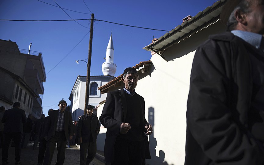 Pilgrims walk outside Kirmahalle Cammi mosque in the northeastern Greek town of Komotini. (AP Photo/Giannis Papanikos, File)