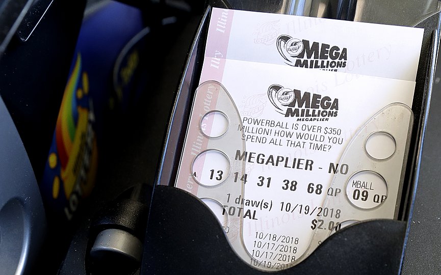 Mega Millions lottery tickets are printed out of a lottery machine at a convenience store Wednesday, Oct. 17, 2018, in Chicago.  (AP Photo/Nam Y. Huh)