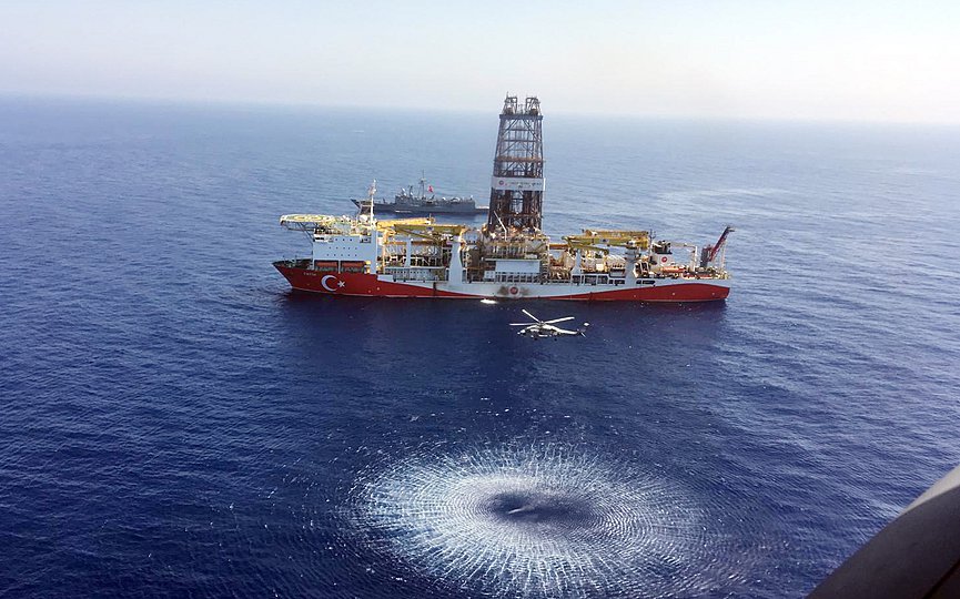 FILE- In this Tuesday, July 9, 2019 photo, a helicopter flies over Turkey's drilling ship, 'Fatih' dispatched towards the eastern Mediterranean, near Cyprus. (Turkish Defence Ministry via AP, Pool)