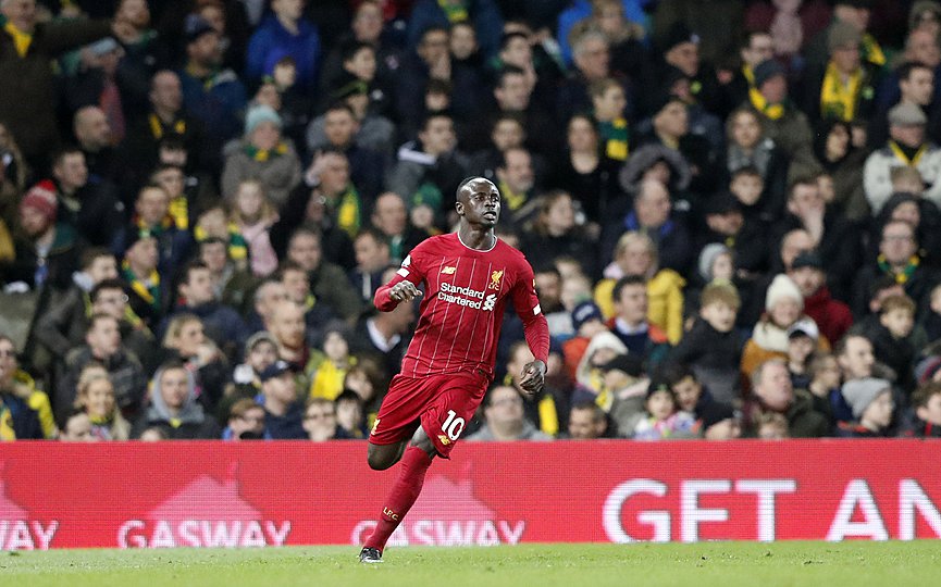 Liverpool's Sadio Mane celebrates after scoring his side's opening goal during the English Premier League soccer match between Norwich City and Liverpool at Carrow Road Stadium in Norwich, England, Saturday, Feb. 15, 2020. (AP Photo/Frank Augstein)