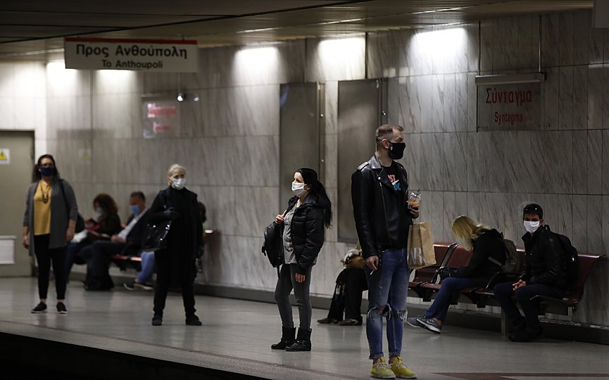 Commuters wearing face masks now obligatory in public transport, to prevent the spread of new coronavirus, wait at Syntagma Metro station during rush hour in central Athens, Monday, May 4, 2020.(AP Photo/Thanassis Stavrakis)