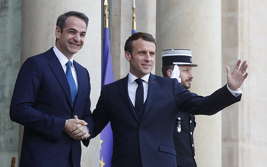 FILE- French President Emmanuel Macron, right, welcome Greek Prime Minister Kyriakos Mitsotakis before their talks Wednesday, Jan. 29, 2020 in Paris. (AP Photo/Thibault Camus)
