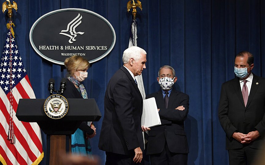 Vice President Mike Pence, second from left, walks off of the stage following the conclusion of a briefing with the Coronavirus Task Force at the Department of Health and Human Services in Washington, Friday, June 26, 2020. (AP Photo/Susan Walsh)