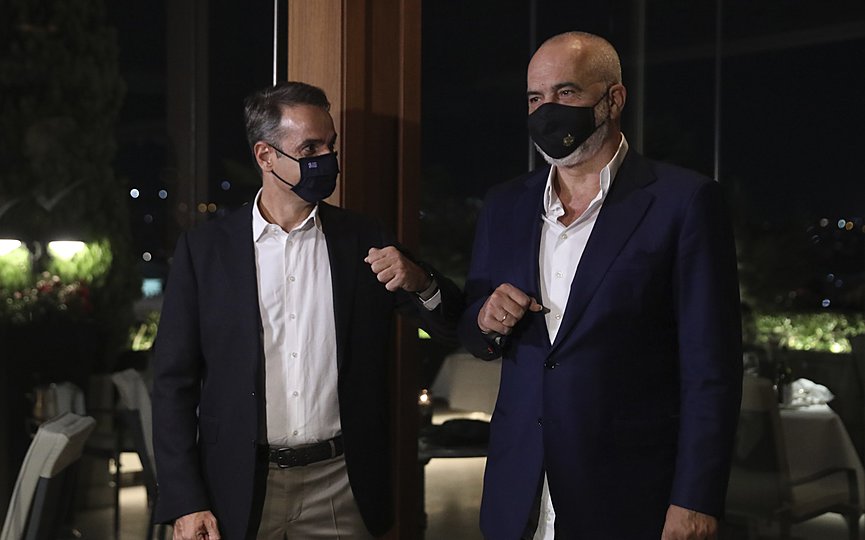 Greek Prime Minister Kyriakos Mitsotakis, left, greets his Albanian counterpart Edi Rama before a working dinner in Athens, Tuesday, Sept. 15, 2020. (Costas Baltas/Pool via AP)