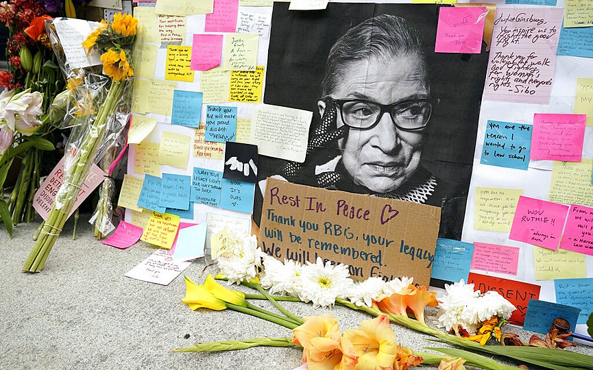 A memorial to U.S. Supreme Court Justice Ruth Bader Ginsburg includes a photograph of the late Justice, Tuesday, Sept. 22, 2020, outside the Harvard Law School library at Langdell Hall, on the campus of Harvard University, in Cambridge, Mass. (AP Photo/Steven Senne)
