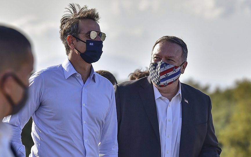 US Secretary of State Mike Pompeo, right, and Greek Prime Minister Kyriakos Mitsotakis visit the archeological site of Aptera, on the Greek island of Crete, on Tuesday, Sept. 29, 2020. (Aris Messinis/Pool via AP)