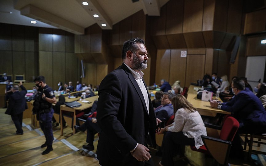 European Parliament member Ioannis Lagos, who had been found guilty along with others of leading a criminal organization and face five to 15 years in prison, walks during a break of a court session on his sentencing in Athens, Monday, Oct. 12, 2020. (AP Photo/Petros Giannakouris)
