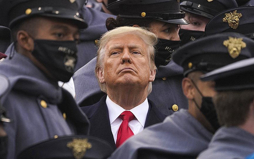 Surrounded by Army cadets, President Donald Trump watches the first half of the 121st Army-Navy Football Game in Michie Stadium at the United States Military Academy, Saturday, Dec. 12, 2020, in West Point, N.Y. (AP Photo/Andrew Harnik)