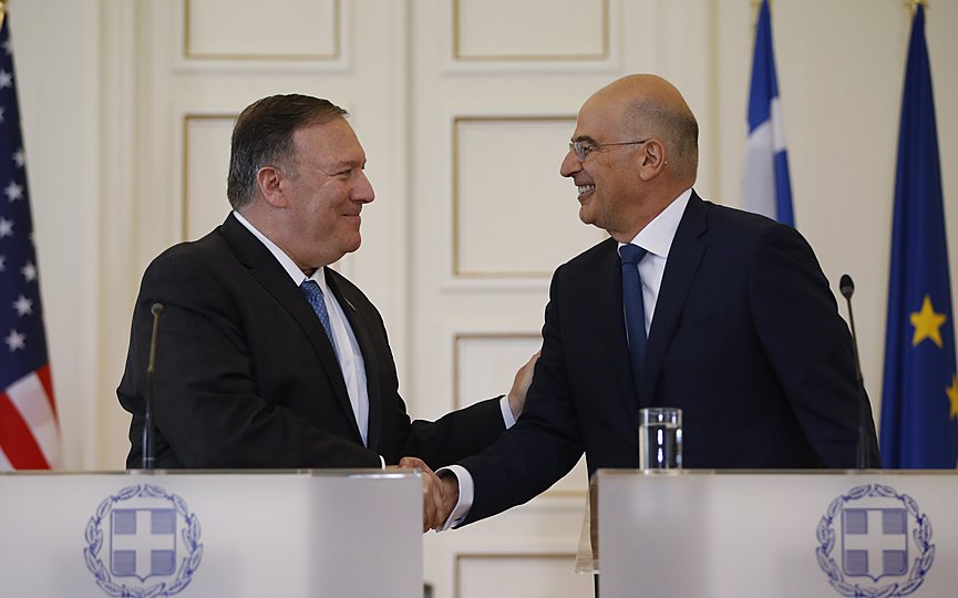 FILE- Greek Foreign Minister Nikos Dendias, right, shakes hands with U.S. Secretary of State Mike Pompeo, right, following their joint news conference after their meeting at the Foreign Ministry in Athens, Saturday, Oct. 5, 2019. (AP Photo/Thanassis Stavrakis)