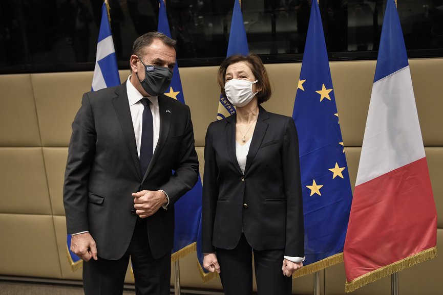 French Defense Minister Florence Parly, right, and his Greek counterpart Nikos Panagiotopoulos speak during their meeting in Athens, Monday, Jan. 25, 2021. (Louisa Gouliamaki/Pool via AP)
