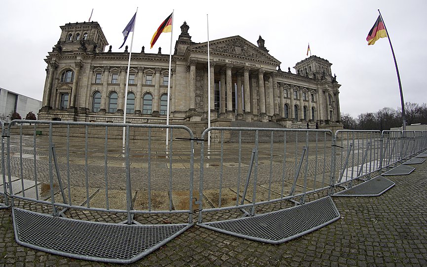 Crowd control barriers are placed in front of the Reichstag building, home of the German federal parliament (Bundestag), in Berlin, Germany, Tuesday, Jan. 12, 2021. (AP Photo/Michael Sohn)
