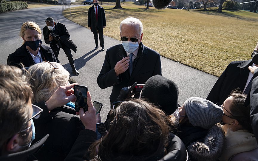 President Joe Biden talks with reporters after arriving on the South Lawn of the White House, Monday, Feb. 8, 2021, in Washington. (AP Photo/Evan Vucci)