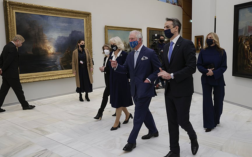 Greek Prime Minister Kyriakos Mitsotakis, right, his wife Mareva Grabowski-Mitsotakis, background right, and Britain s Prince Charles, second center, with his wife Camilla, the Duchess of Cornwall, visit Greece s newly renovated National Gallery in Athens, March 24, 2021. (Alkis Konstantinidis/Pool via AP)