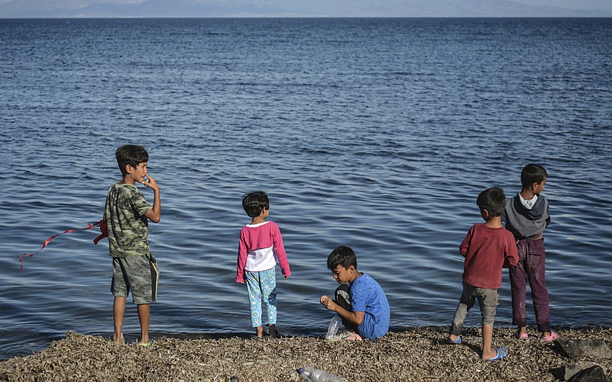 FILE- Children stand by the sea at the Kara Tepe refugee camp, on the northeastern Aegean island of Lesbos, Greece, Wednesday, Oct. 14, 2020. (AP Photo/Panagiotis Balaskas)