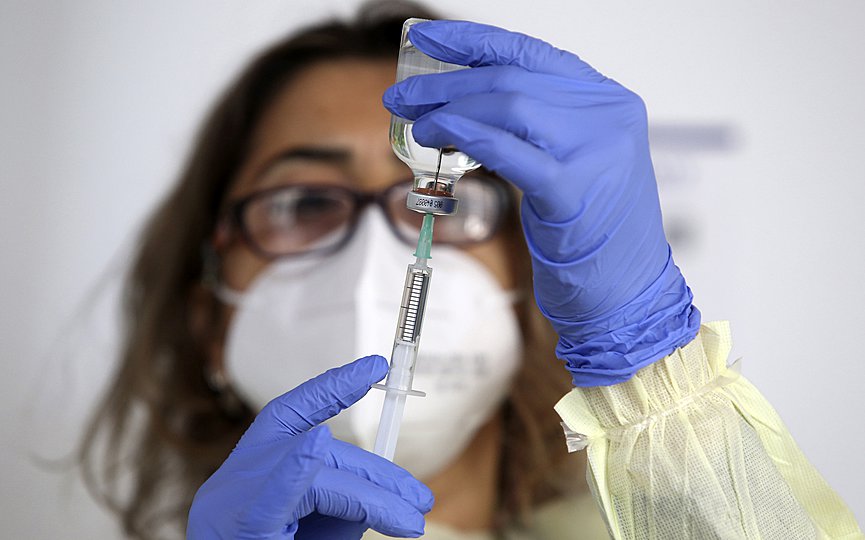 A nurse prepares to administer of Pfizer BioNtech against the COVID-19, at a care home in Nicosia, Cyprus, on Sunday, Dec. 27, 2020. Cyprus started today the vaccination program against COVID-19. (Katia Christodoulou/Pool Photo via AP)