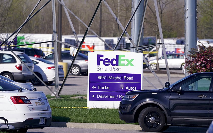 Vehicles are parked at the scene where multiple people were shot at the FedEx Ground facility early Friday morning, April 16, 2021, in Indianapolis. (AP Photo/Michael Conroy)