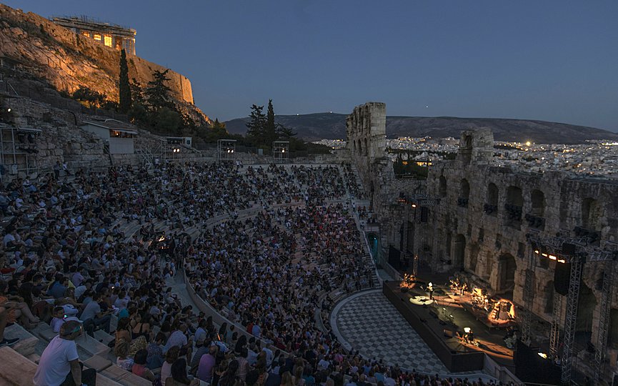 FILE- Actors and singers perform at the Odeon of Herodes Atticus in Athens, Greece, after the site was reopened for performances on Wednesday, July 15, 2020, with the ancient Parthenon temple in the background. (AP Photo/Petros Giannakouris)