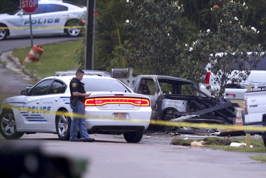 Hattiesburg police surround a burned automobile and a damaged home after a small plane crashed late Tuesday night in Hattiesburg, Miss.,  Wednesday May 5, 2021.  (Chuck Cook /The Advocate via AP)