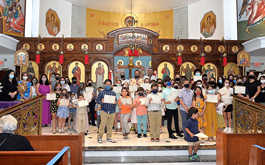 The students of the Sunday School at St. Thomas Greek Orthodox Church in Cherry Hill, NJ posed with their certificates and Fr. Christoforos Oikonomidis, presiding priest of the community. Photo: Steve Lambrou