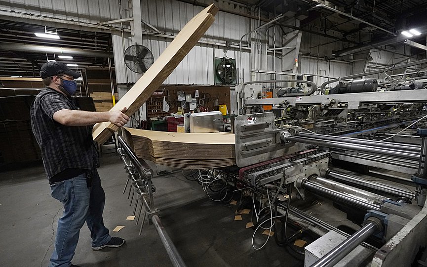 Rob Bondurant, a supervisor at Great Southern Industries, a packaging company, loads up a finishing machine in the Jackson, Miss., facility, Friday, May 28, 2021. (AP Photo/Rogelio V. Solis)