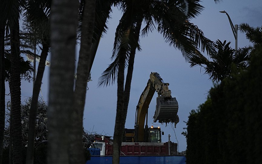 FILE - In this July 15, 2021 file photo, an excavator clears rubble at the site of the Champlain Towers South condo building collapse and demolition in Surfside, Fla.  (AP Photo/Rebecca Blackwell, File)