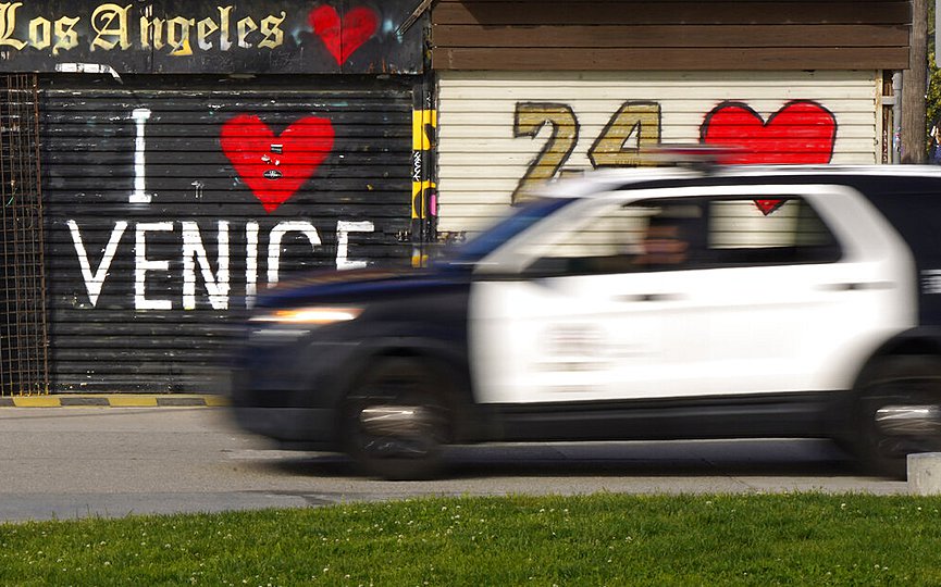 FILE- A Los Angeles Police Department vehicle patrols the Venice Beach Boardwalk during the coronavirus outbreak Saturday, April 25, 2020, in the Venice section of Los Angeles. (AP Photo/Mark J. Terrill)