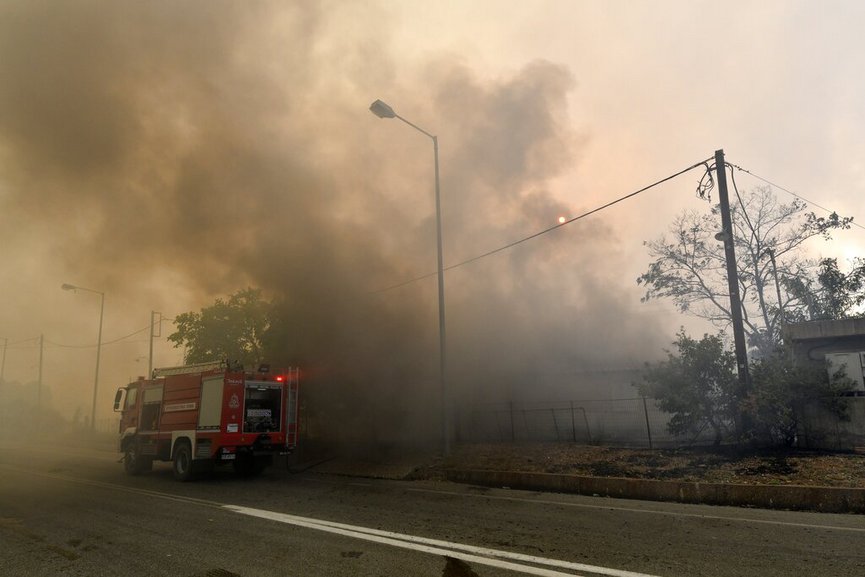Firefighters try to extinguish a wildfire in Lalas village, near Olympia town, western Greece, Thursday, Aug. 5, 2021. (Giannis Spyrounis/ilialive.gr via AP)