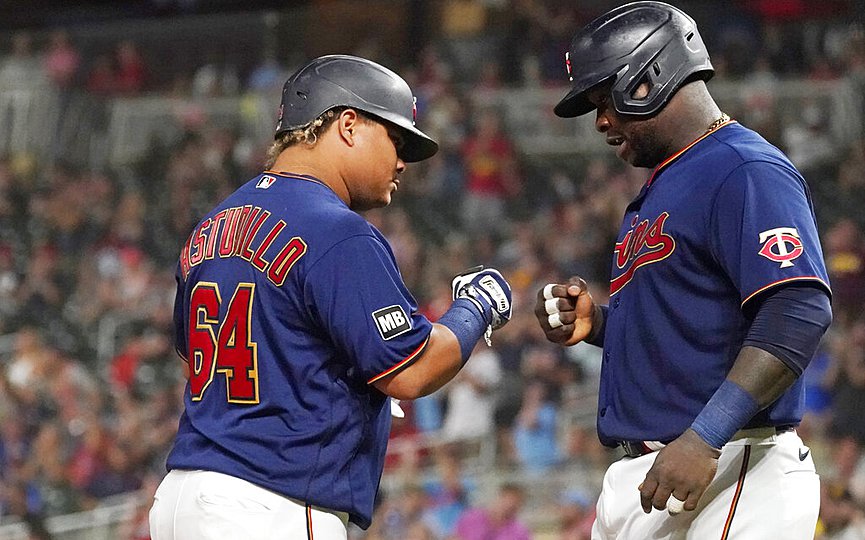 Minnesota Twins  Willians Astudillo (64) is congratulated by Miguel Sano following his two-run home run off Chicago White Sox pitcher Dallas Keuchel during the sixth inning of a baseball game Tuesday, Aug. 10, 2021, in Minneapolis. (AP Photo/Jim Mone)