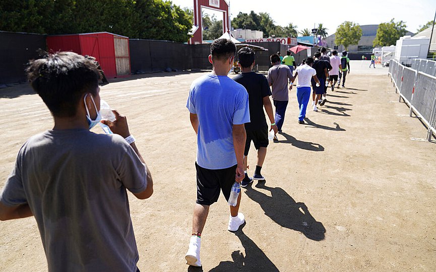 FILE - In this July 2, 2021, file photo, children walk together after a game of soccer at an emergency shelter for migrant children in Pomona, Calif. (AP Photo/Marcio Jose Sanchez, Pool, File)