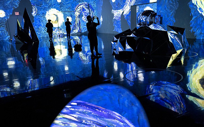 FILE- Projections of selected works of celebrated painter Vincent Van Gogh are displayed at a preview of the Immersive Van Gogh exhibit at Pier 36, Friday, June 4, 2021, in New York. (AP Photo/John Minchillo)