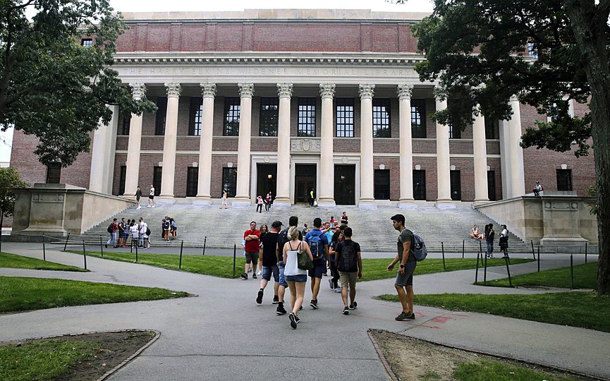 FILE - In this Aug. 13, 2019 file photo, students walk near the Widener Library in Harvard Yard at Harvard University in Cambridge, Mass. (AP Photo/Charles Krupa, File)