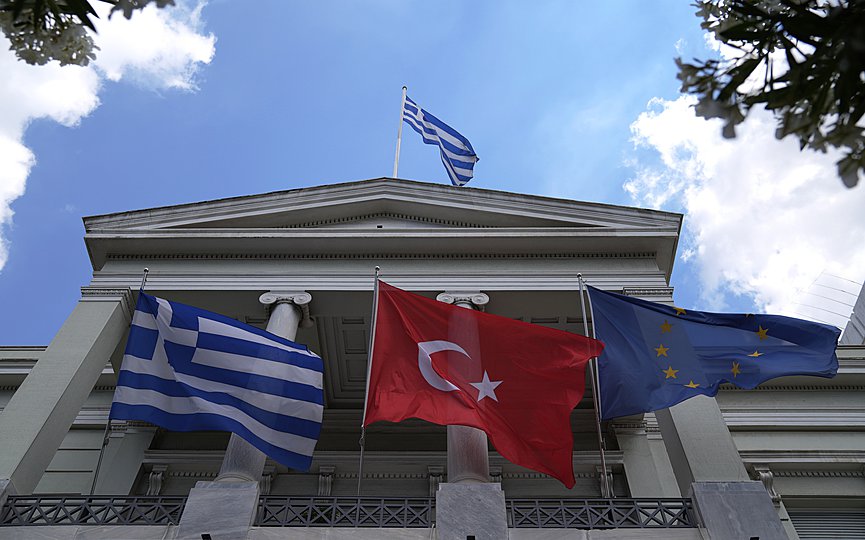 FILE- Greek, left, Turkish and European Union flags wave on the foreign ministry house before a meeting of Greek Foreign Minister Nikos Dendias and his Turkish counterpart Mevlut Cavusoglu in Athens, Monday, May 31, 2021. (AP Photo/Thanassis Stavrakis)