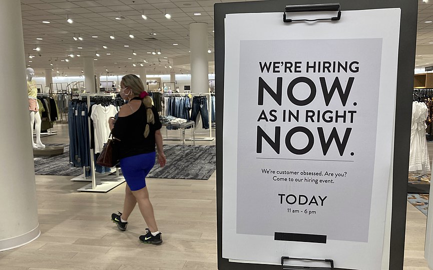 FILE - In this May 21, 2021 file photo, a customer walks behind a sign at a Nordstrom store seeking employees in Coral Gables, Fla. (AP Photo/Marta Lavandier, File)