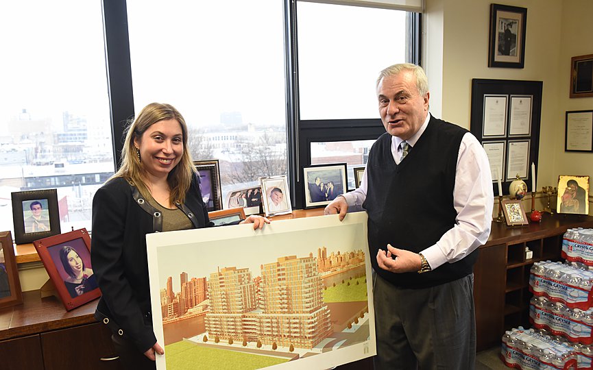 Sophia Valiotis, CEO of Alma Realty, with her father and President of the company Efstathios Valiotis, holding a sketch of one of their building projects in Long Island City. PHOTO: by Costas Bej.