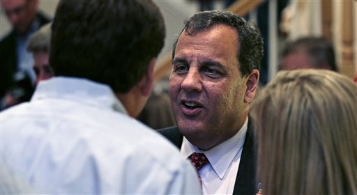 New Jersey Gov. Chris Christie talks with guests at a house party in Bedford, N.H., Monday, June 8, 2015.  Christie is testing the waters as he considers a run for the Republican nomination for president in the nation's earliest presidential primary state. (AP Photo/Charles Krupa)