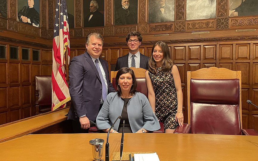 Madeline Singas, seated, was sworn in as an Associate Judge on the New York State Court of Appeals, the highest court in New York, with her husband Theo Apostolou, and their children, Vassili and Demetra, present. Photo: Courtesy of Madeline Singas